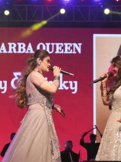 The "Garba Queen" title on the screen behind us is an honor we cherish. We work hard to live up to it at every single show.