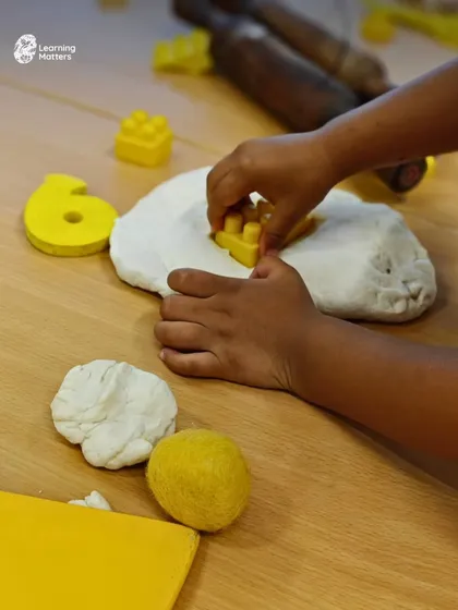 With every press of a block into dough, a child strengthens the small muscles in their hands needed for writing and self-care. This is a perfect example of how we build foundational fine motor skills through purposeful, open-ended play.