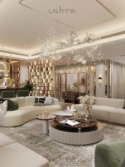 An immersive living space that redefines contemporary luxury. This view shows the seamless flow from the lounge with its curved sofas to the elegant bar area, all under the glow of sculptural lighting.