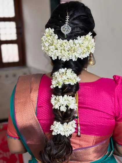 Bridal braid inspiration, featuring a thick braid adorned with beautiful fresh gajra.