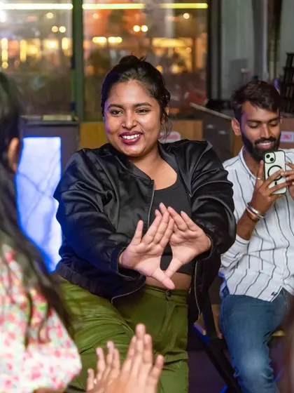 A guest showing off her dance moves while her friend captures the moment. It's all about fun and making memories.