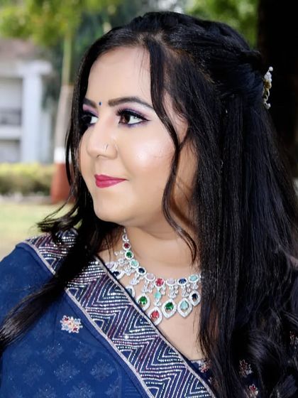 A close-up portrait showing the details of the engagement makeup, with a focus on the eyes and the stunning jewelry.