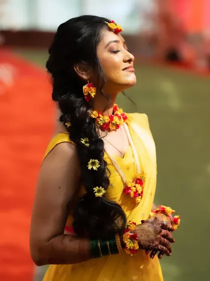 A sun-kissed Haldi look. The makeup is warm and glowing, perfect for an outdoor daytime ceremony.