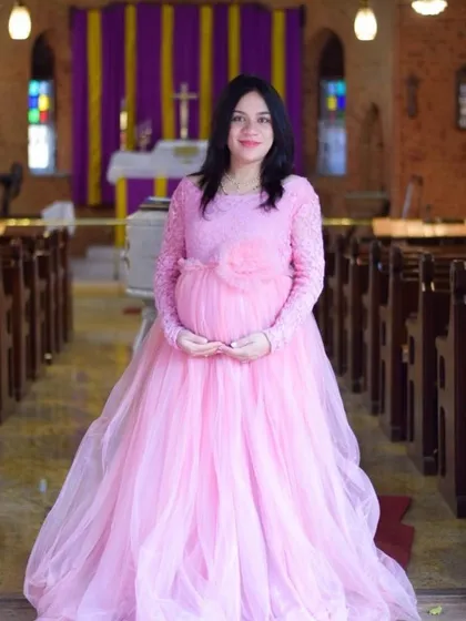 This pink lace-sleeve gown is elegant and modest, making it a beautiful choice for a maternity shoot in a church or other special location.