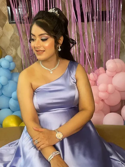 The beautiful lavender gown and glowing makeup create a perfect look for a baby shower celebration.