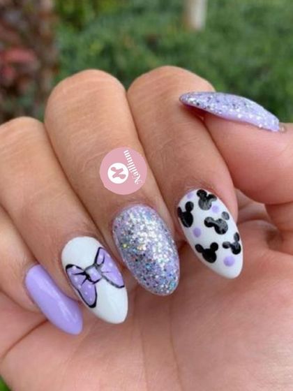 A cute and playful set for the Disney lover. This design features Minnie and Mickey Mouse silhouettes, a purple glitter accent, and a 3D bow.