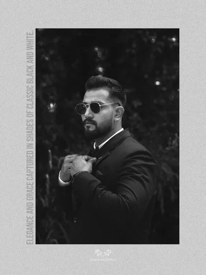 A classic black and white portrait of the groom, exuding timeless style and grace in his wedding attire.