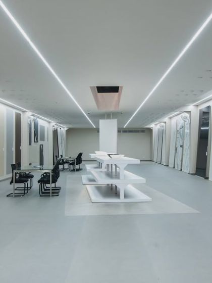 More images from the Krsimar marble showroom, detailing the sliding panel display system and the clean, spacious layout designed for an optimal client experience.