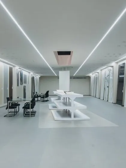 More images from the Krsimar marble showroom, detailing the sliding panel display system and the clean, spacious layout designed for an optimal client experience.