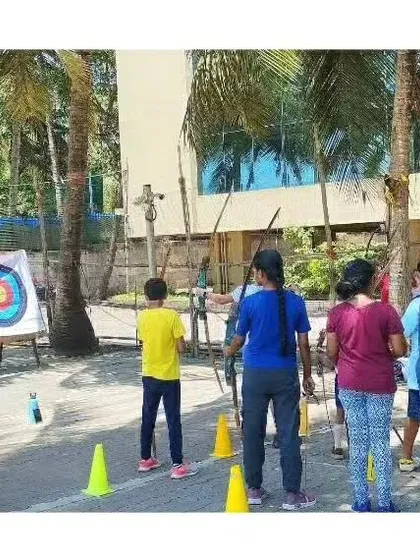 A coach observing students as they take aim. Constant supervision ensures safety and allows for immediate feedback.