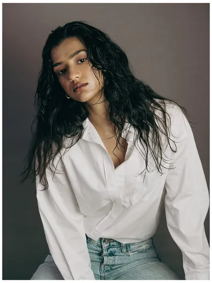 This shot provides a clear view of the full "wet look" hairstyle. The model's direct gaze adds confidence, while the styling remains the hero. It's a clean, effective shot for a hair stylist's portfolio or a product campaign.