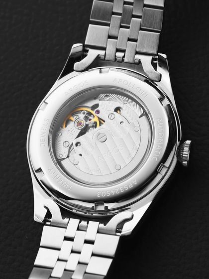 A clean, high-key shot of the back of an Argos watch. Unlike the dramatic shot of the Olympus, this one is bright and clinical, focusing purely on the mechanical details of the movement against a simple black leather background.