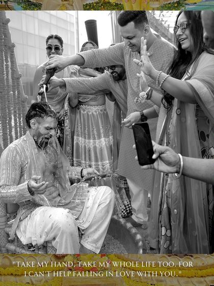 We believe in capturing both the color and the emotion. This black and white shot focuses on the groom's reaction as he is doused with water during his Haldi, highlighting the fun and chaos of the moment.