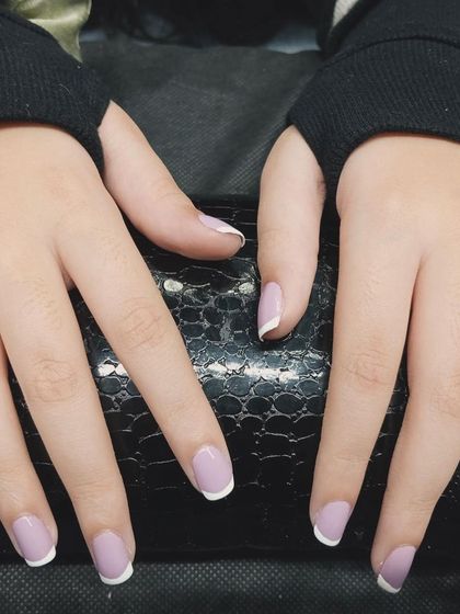 A modern take on the French manicure. This design features a soft lavender base with clean, white tips for a fresh and stylish look.