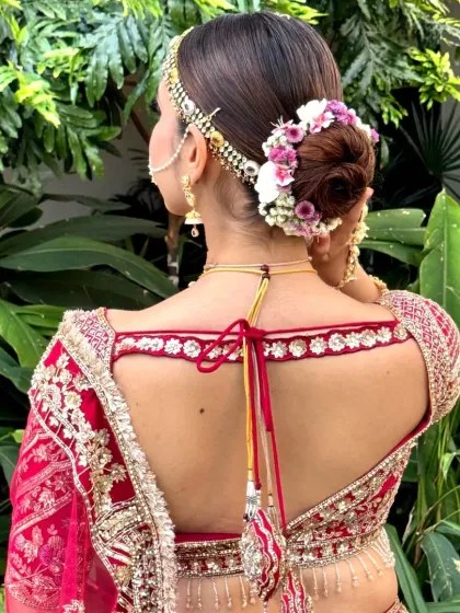 A clean and clear back view of a floral bun, perfect for a bride seeking a classic and elegant hairstyle. The flowers add a soft, romantic touch.