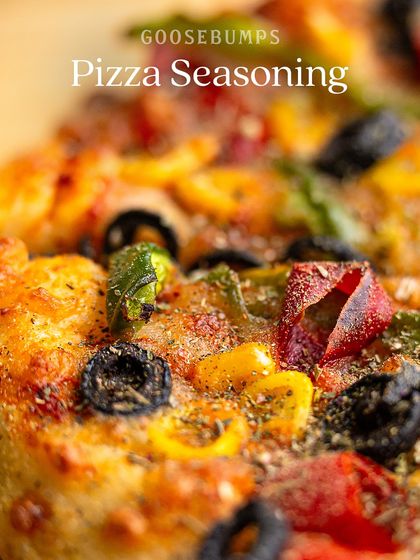 A close-up shot of my Pizza Seasoning generously sprinkled over a fresh, hot pizza. You can see the specks of oregano, basil, and chilli that bring so much flavour to every bite.