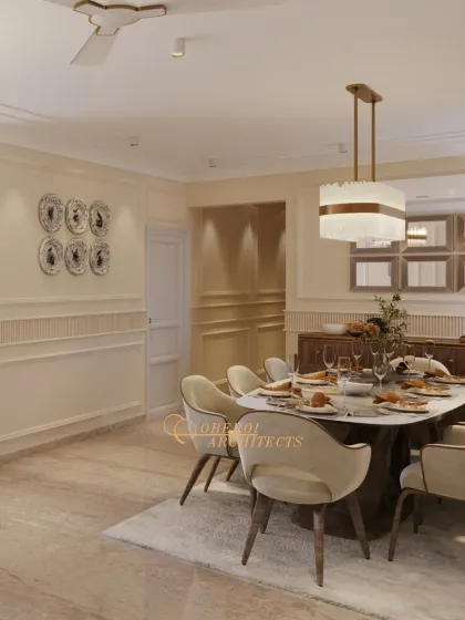 The dining area features an oval table and plush chairs, set under a contemporary chandelier, creating a welcoming space for family meals.