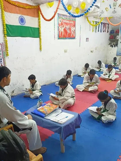 Progress in Taekwondo is not just physical. Here, our students are taking the written exam portion of their belt upgrading test, showing their knowledge of the art's principles and history.