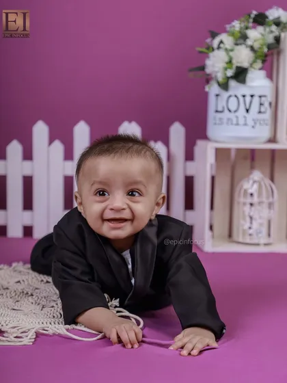 A huge, happy smile from this crawling baby. The simple purple background keeps the focus entirely on your child's infectious joy.