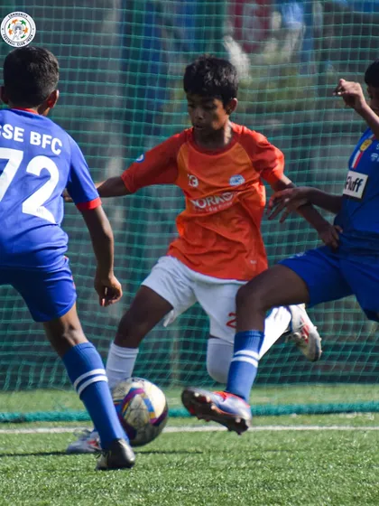 An intense midfield battle during a U13 match. We provide valuable competitive experience against other top academies.