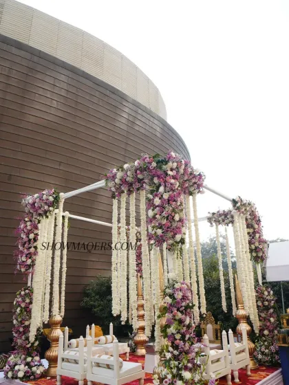 A wide view of the floral wedding mandap setup against the modern architecture of The Westin. We excel at integrating grand decor into diverse venue spaces.