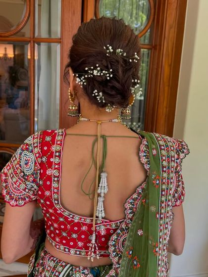 A detailed shot of a messy updo with baby's breath, perfect for a daytime event.