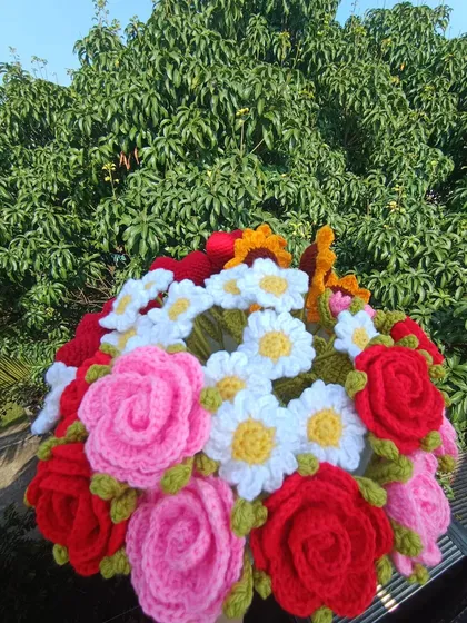 A stunning mixed bouquet of roses, daisies, and sunflowers.