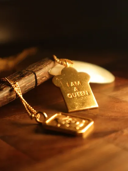 This "I am a Queen" pendant is a powerful little reminder. It’s crafted from sterling silver with 18k gold plating, because you deserve to feel like royalty every day.