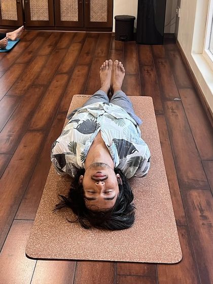 A student rests in Matsyasana (Fish Pose), a heart-opening pose that also stimulates the throat chakra.