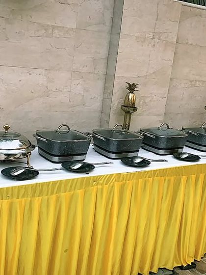 A festive buffet setup for 85 guests in Sainik Farms to celebrate Vasant Panchami. The bright yellow table skirting perfectly matches the spirit of the occasion.