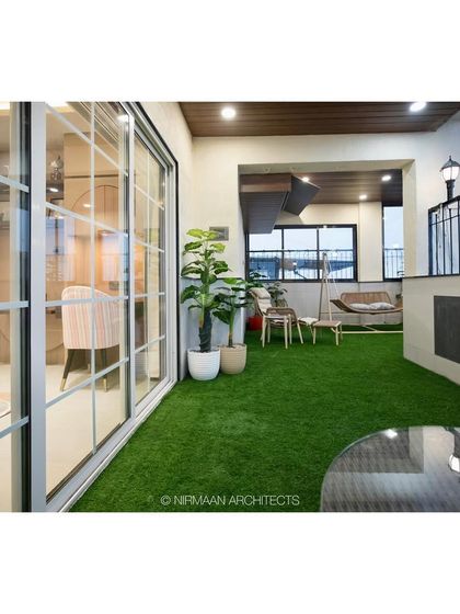 The daughters' bedroom in the Duplex Project opens onto this beautiful terrace with artificial grass. It provides a safe and green outdoor space for play and relaxation.