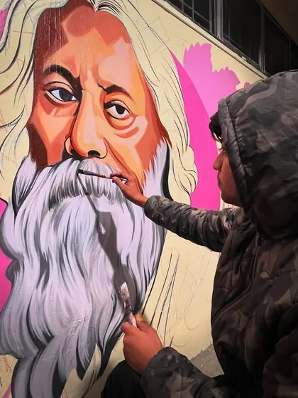 A close-up shot of me adding the final touches to the beard of Rabindranath Tagore. This shows the level of detail and brushwork that goes into creating these large-scale realistic portraits.