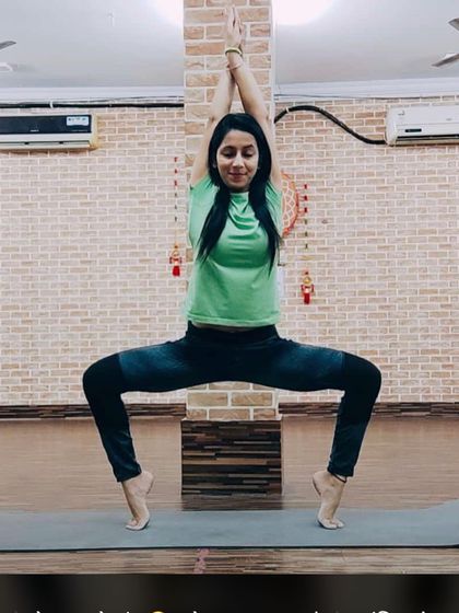 Utkata Konasana, or goddess pose, performed on the toes. This variation adds a serious challenge to your balance and strengthens the entire lower body.
