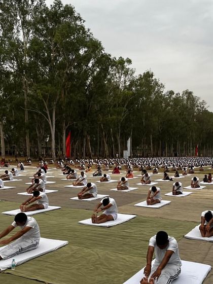 Hundreds of people practice Paschimottanasana (Seated Forward Bend) in unison during our large-scale event in Hoshiarpur. This image powerfully conveys the concept of "One Earth, One Family, One Future."