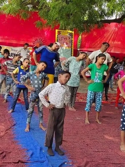Taking our self-defense and fitness training to the community. Here, I am leading a warm-up and basic movement session for children at a government school summer camp.
