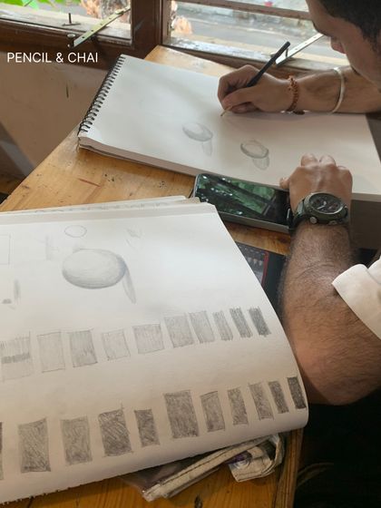 A student's practice sheet showing exercises in shading and form. This disciplined practice is the key to understanding how to render three-dimensional objects.