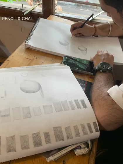 A student's practice sheet showing exercises in shading and form. This disciplined practice is the key to understanding how to render three-dimensional objects.
