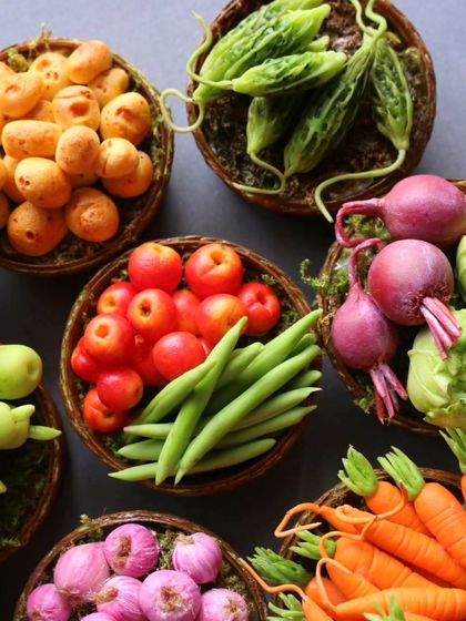 A handful of my miniature vegetable baskets, including tomatoes, beans, and potatoes.