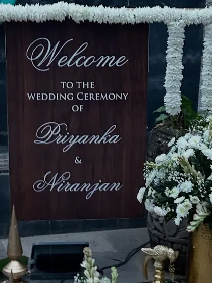 Personal touches make a wedding special. We created this custom wooden welcome sign for a wedding ceremony, framed with elegant white flower garlands to greet guests as they arrive.