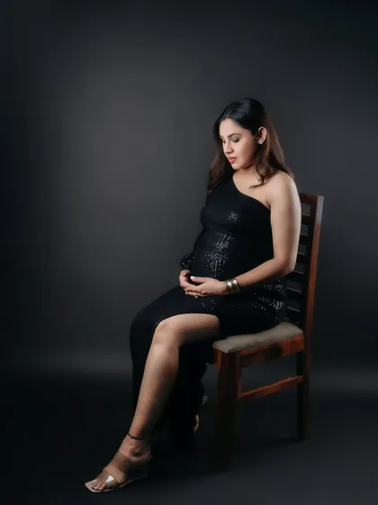 A seated portrait that captures the elegance of the mom-to-be and her gown. This quiet, posed shot in the studio is both graceful and timeless.