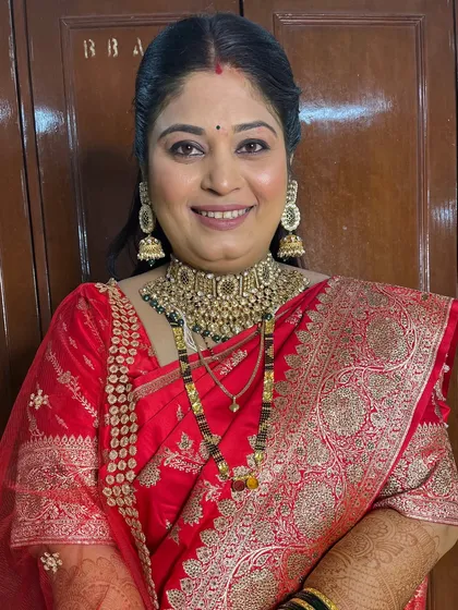 A close-up of the reception makeup, featuring a neutral eye and a soft red lip.