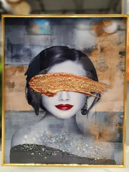 This modern and abstract portrait is a powerful piece of crystal art. The woman's face, partially obscured by a bold, glittering gold brushstroke, creates a mysterious and high-fashion look in this 16x24 inch painting.