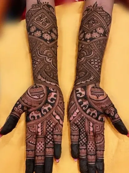 An intricate design filled with elephants, birds, and geometric patterns, offering a dense and rich look for the bride who wants full coverage.