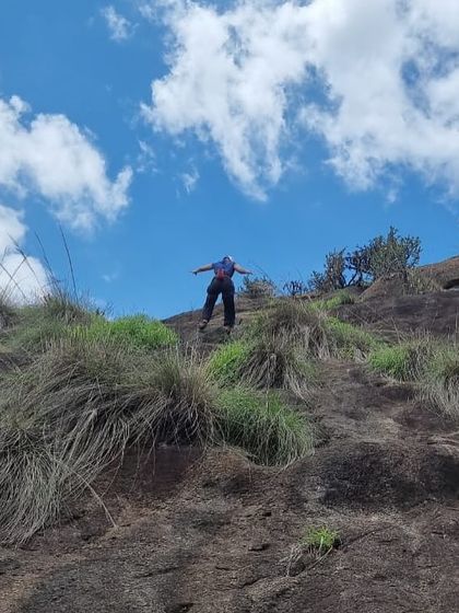 A new climber enjoying the view from the top during our 42nd Intro Workshop. The feeling of accomplishment after reaching the anchor is something we love sharing with every participant.