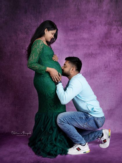 A classic pose of devotion. The dad-to-be kisses the baby bump, showing his love and connection to their unborn child.