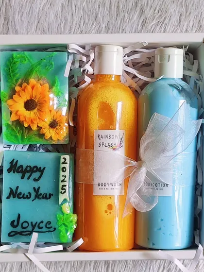 A "Happy New Year 2025" hamper for Joyce. It includes a custom message soap, a sunflower soap, and matching body wash and lotion.