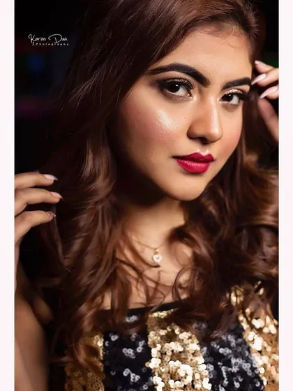 A detailed close-up of a glamorous evening look. You can see the seamless blend of the eyeshadow, the precise application of the bold lipstick, and the radiant skin finish. I use techniques that ensure your makeup is flawless up close and from a distance.