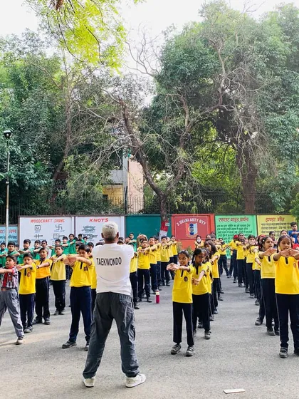 Leading a large group of students at a school workshop is where my passion comes to life. You can see the focus and discipline as they all practice a blocking technique in unison, turning a schoolyard into a training ground for confidence.