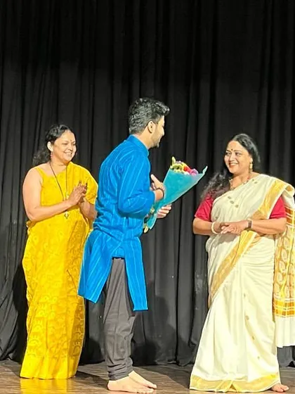 A moment of felicitation on stage with the dancers and organizers.