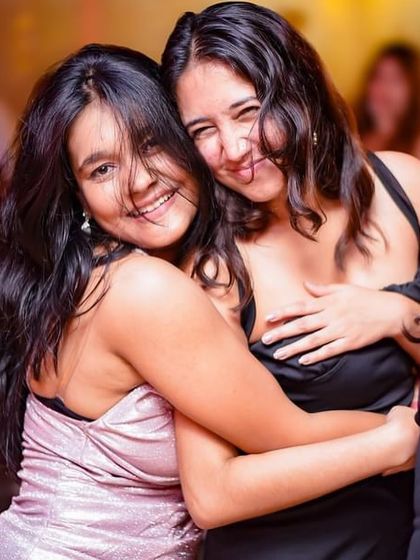 A warm hug between friends on the dance floor.